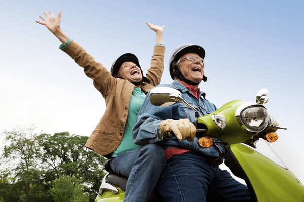 senior couple riding a moped